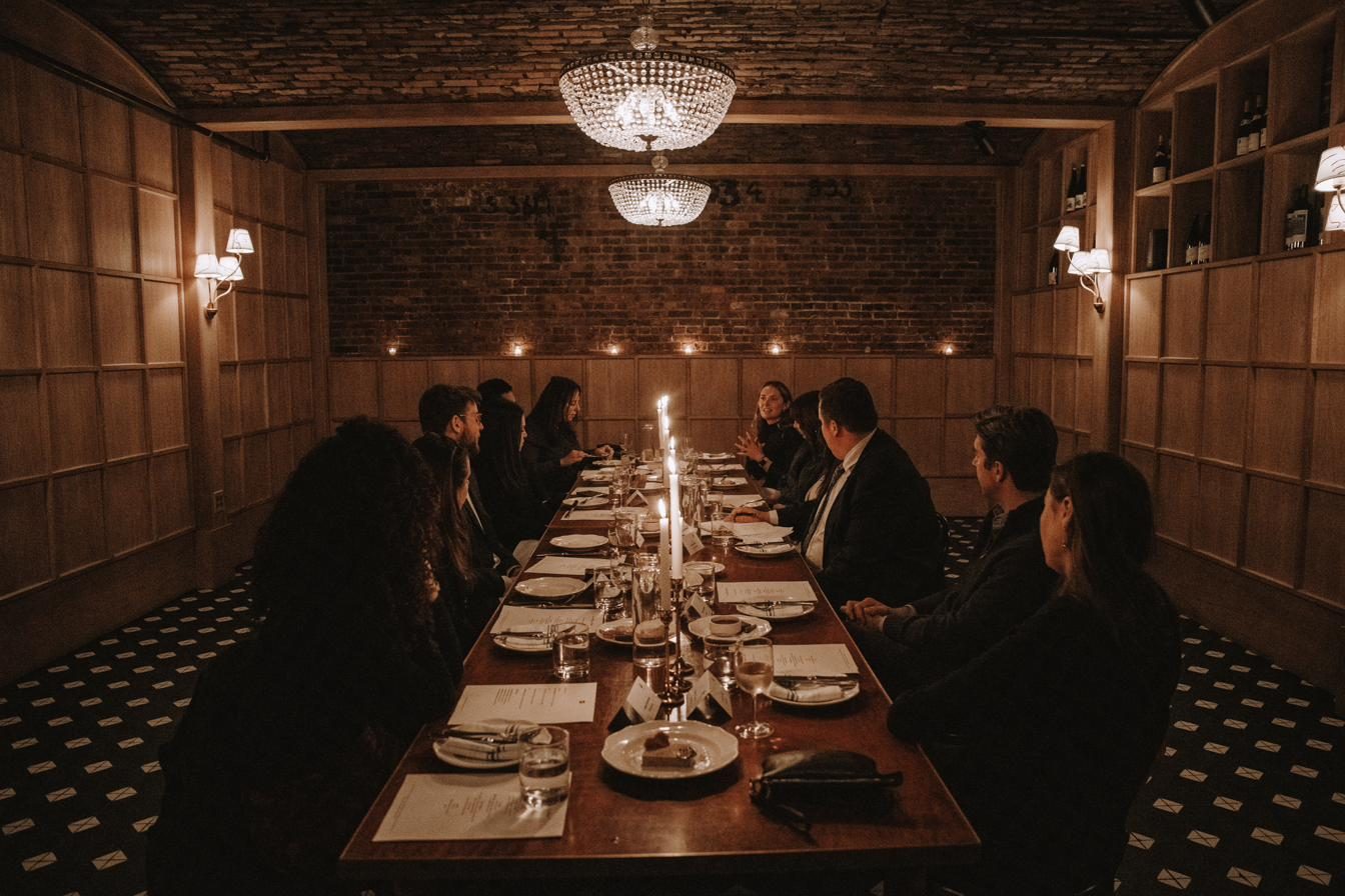 A private dining room set for a closed-door roundtable dinner